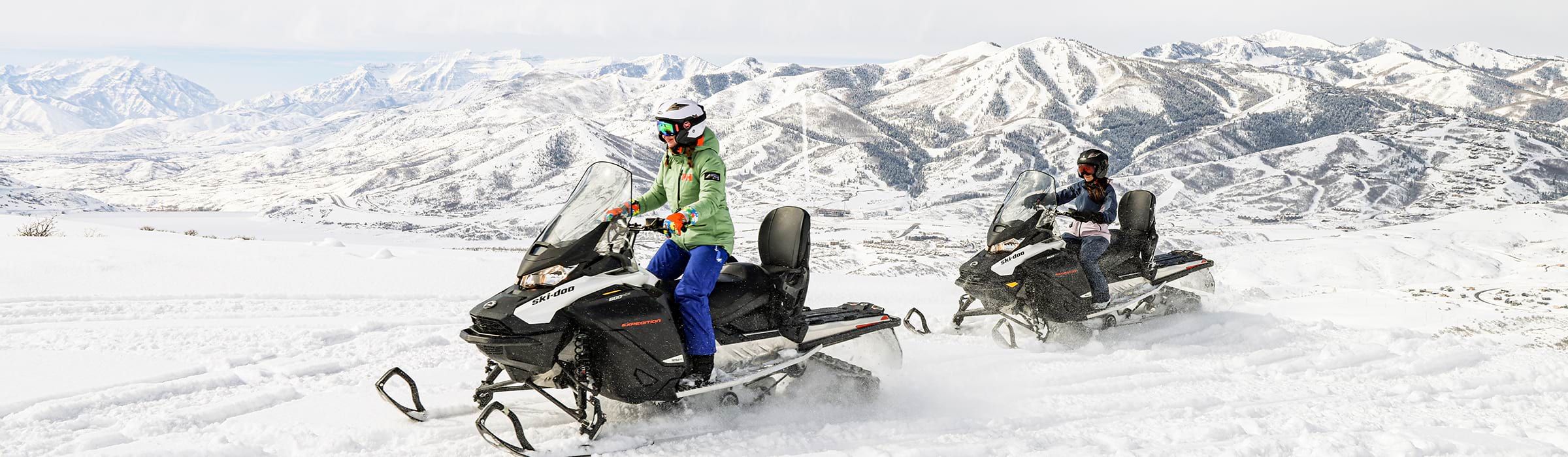 Two women taking snowmobiling tour at Deer Valley.